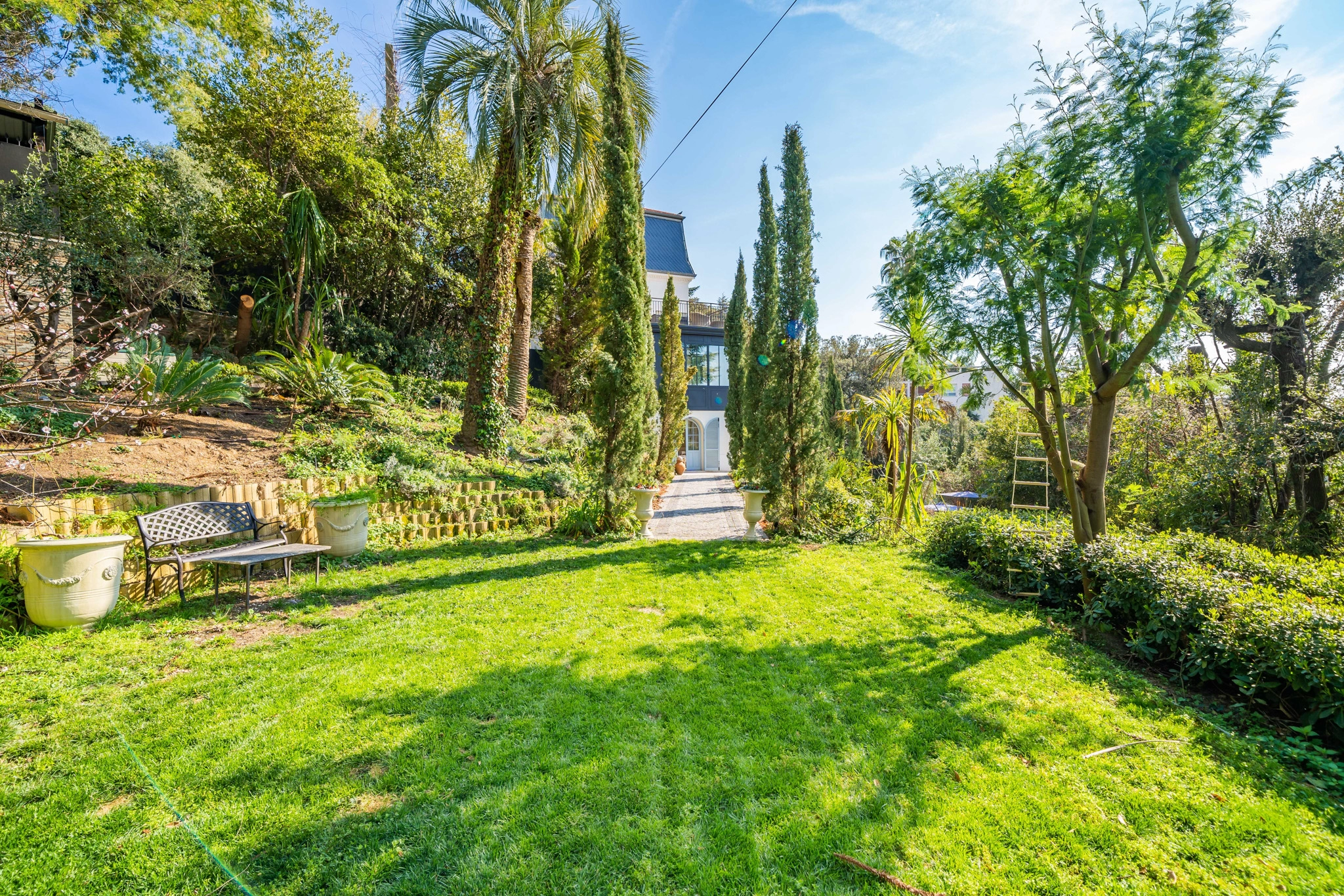 Landscaped Mediterranean Gardens at Château Les Alouettes Landscaped Mediterranean gardens and lawn at Château Les Alouettes luxury villa in Cannes.